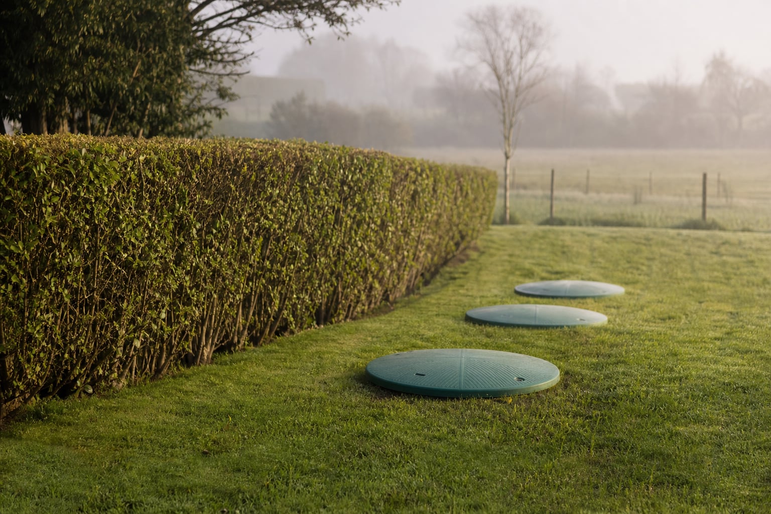 Sewage treatment plant lids in a tidy West Norfolk garden